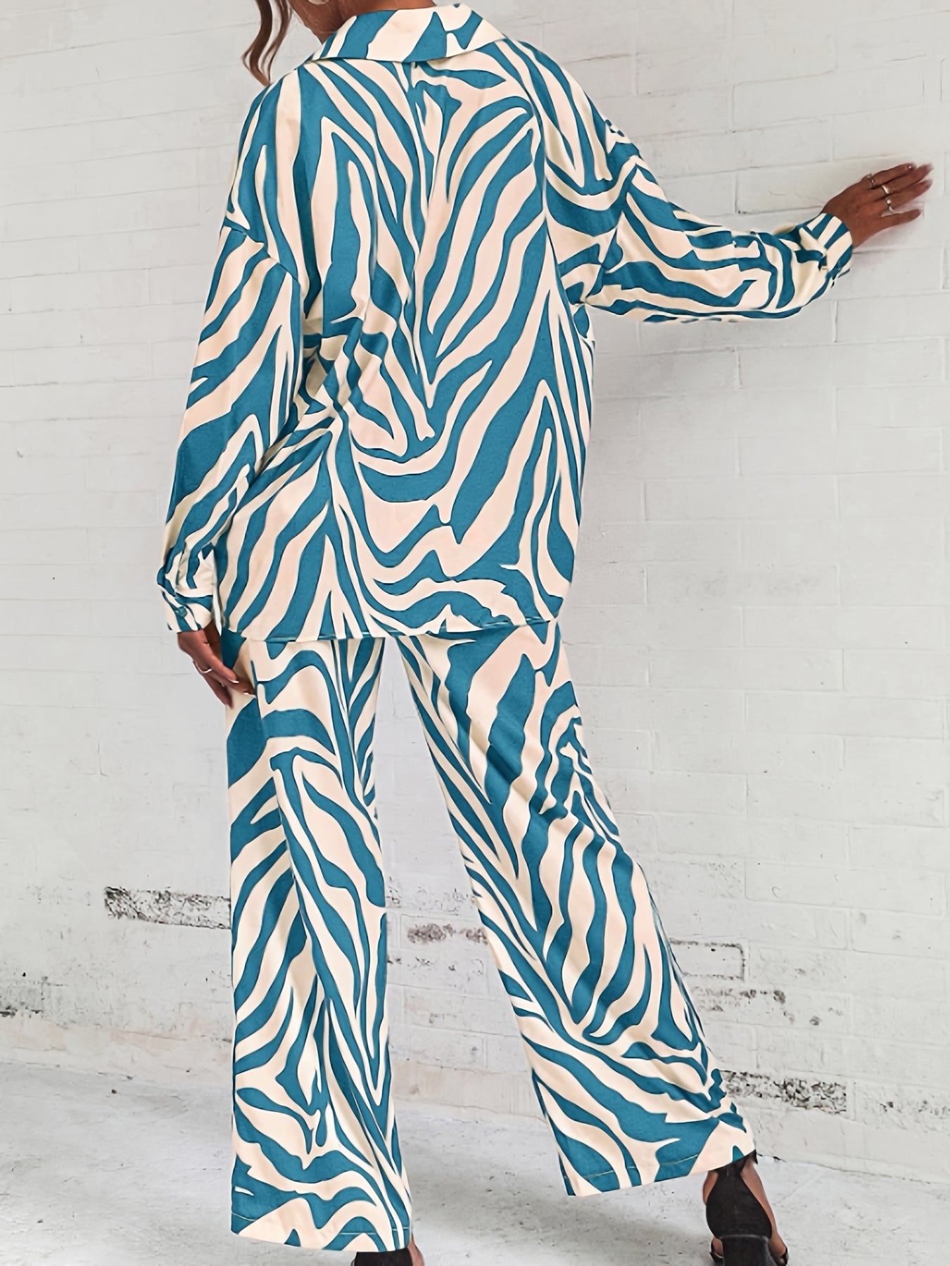 A two-piece home wear set featuring a Women's printed pajama button- lapel top and loose wide-leg pants